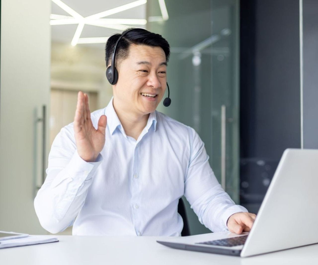 asianmansmilingspeakingintocomputer