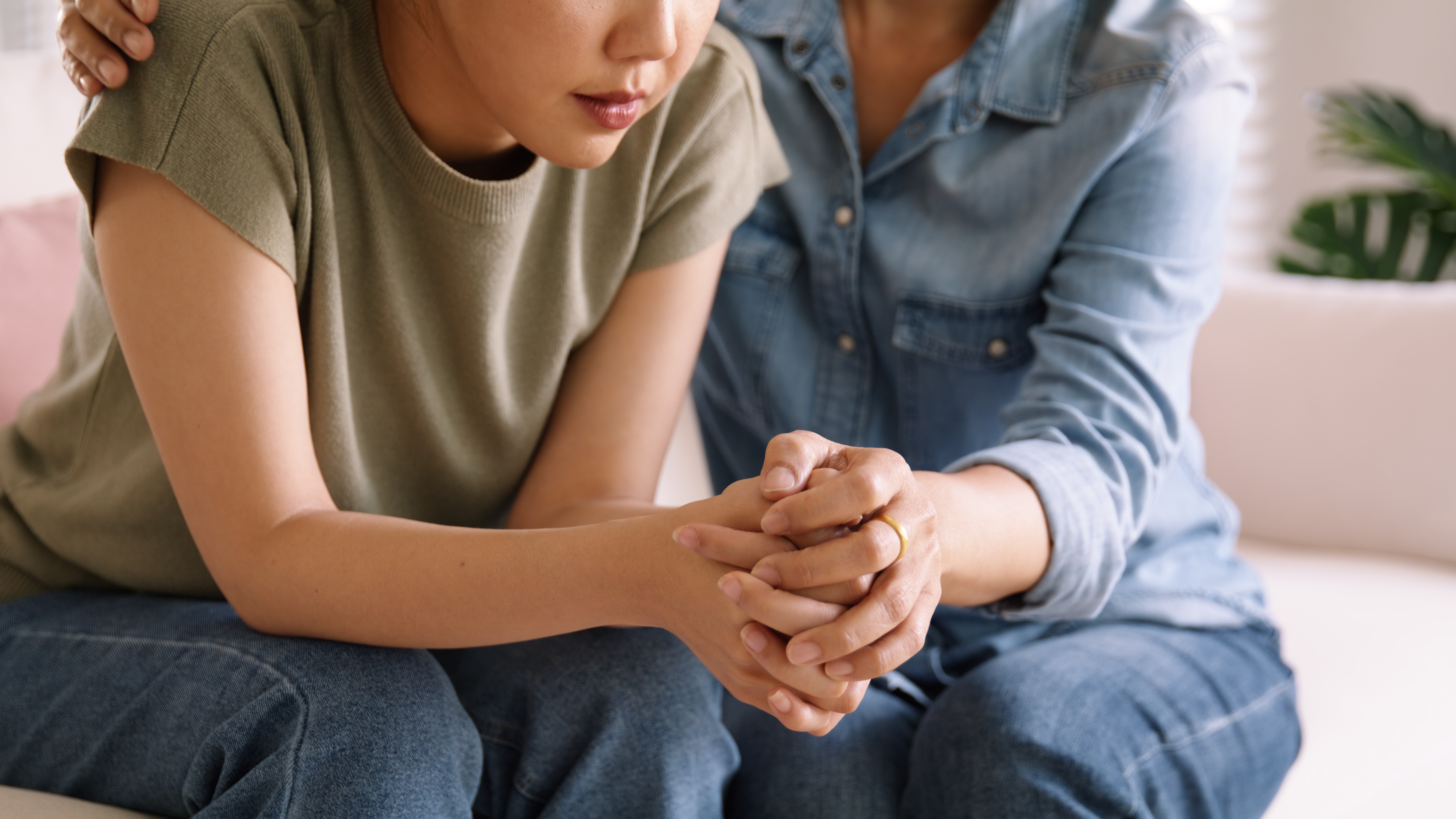 A woman being comforted by a colleague after experiencing workplace harassment
