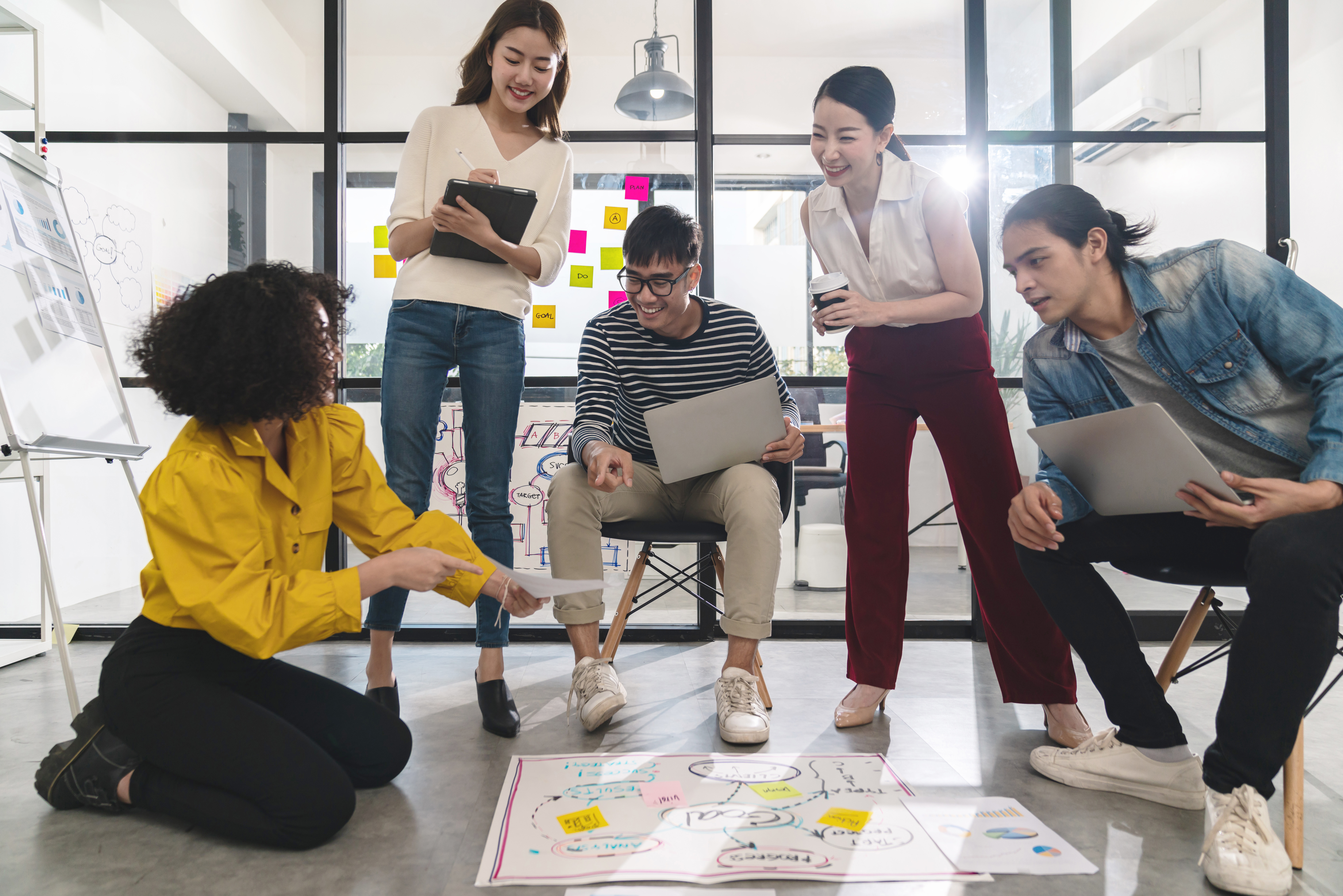 A team of diverse professionals collaborating on a project, showing teamwork and business strategy.