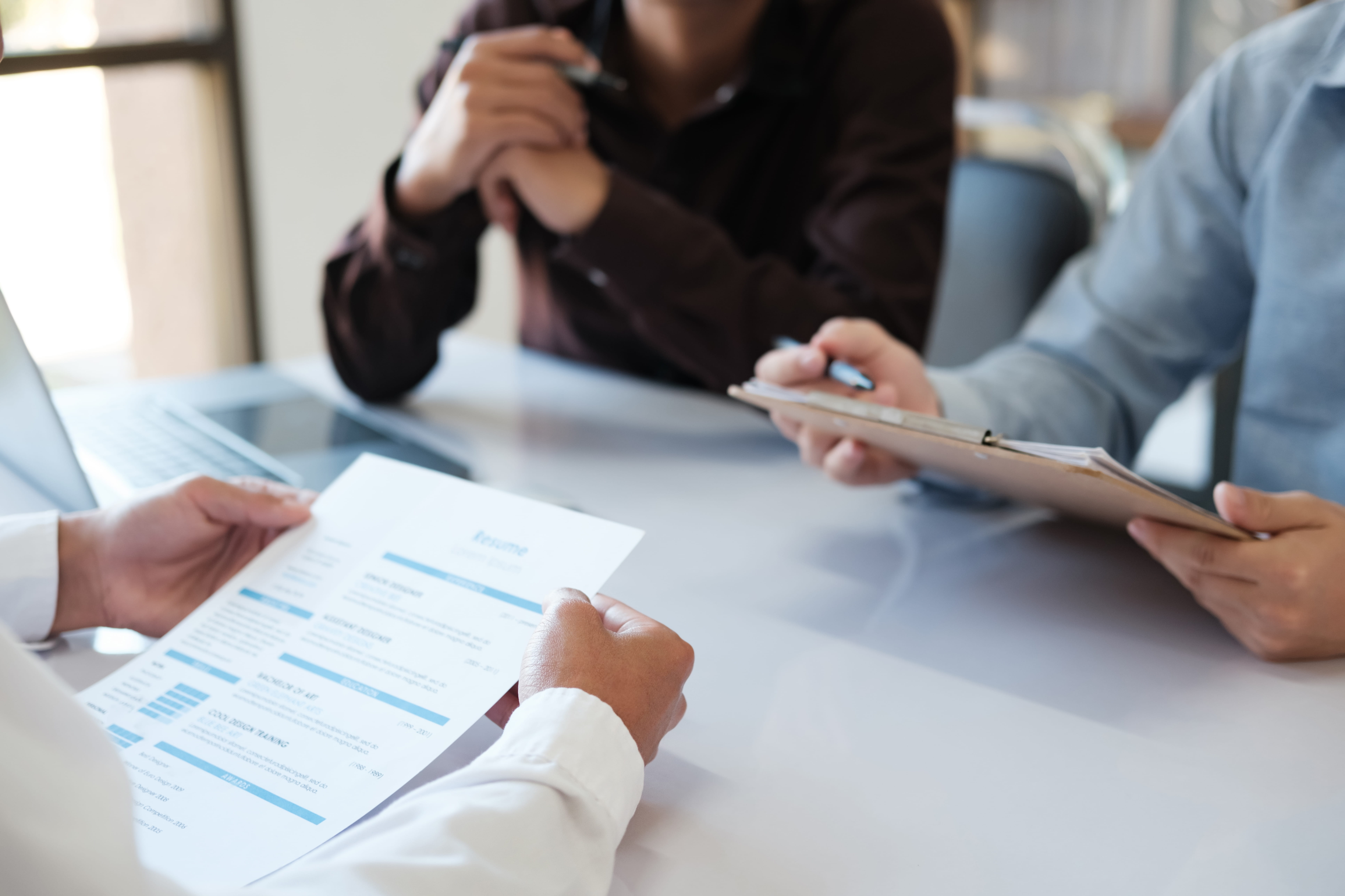 Hiring panel reviewing a candidate’s résumé during a job interview, demonstrating fair hiring practices and job interview fairness.